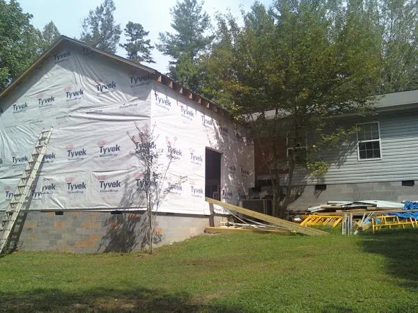 Tyvek wrapped gable on a new room addition beside an existing home in Clarkdale